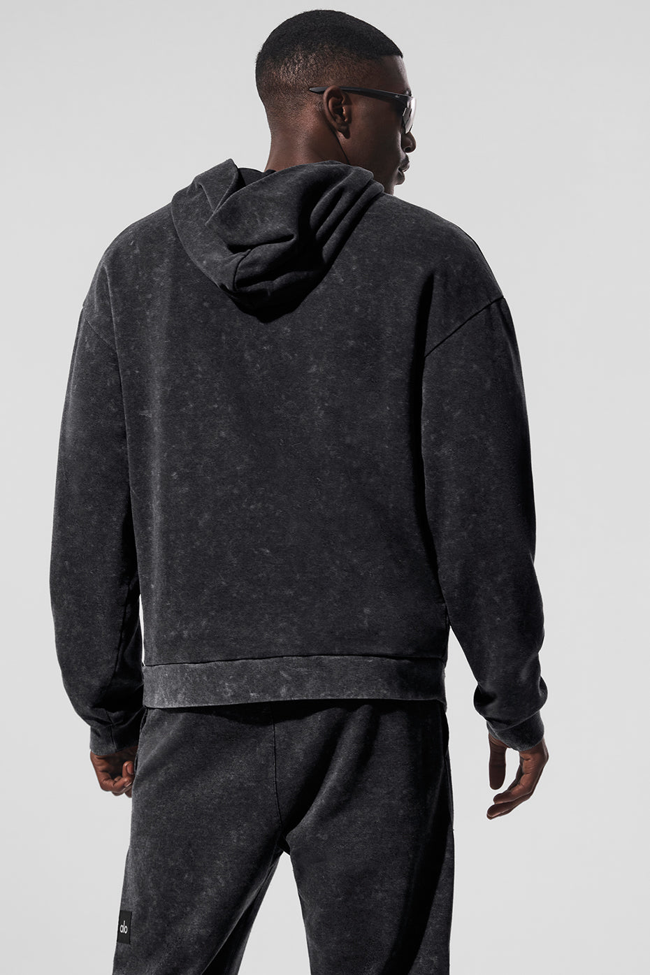 Close-up of ribbed cuffs and hem on the vintage wash hoodie.