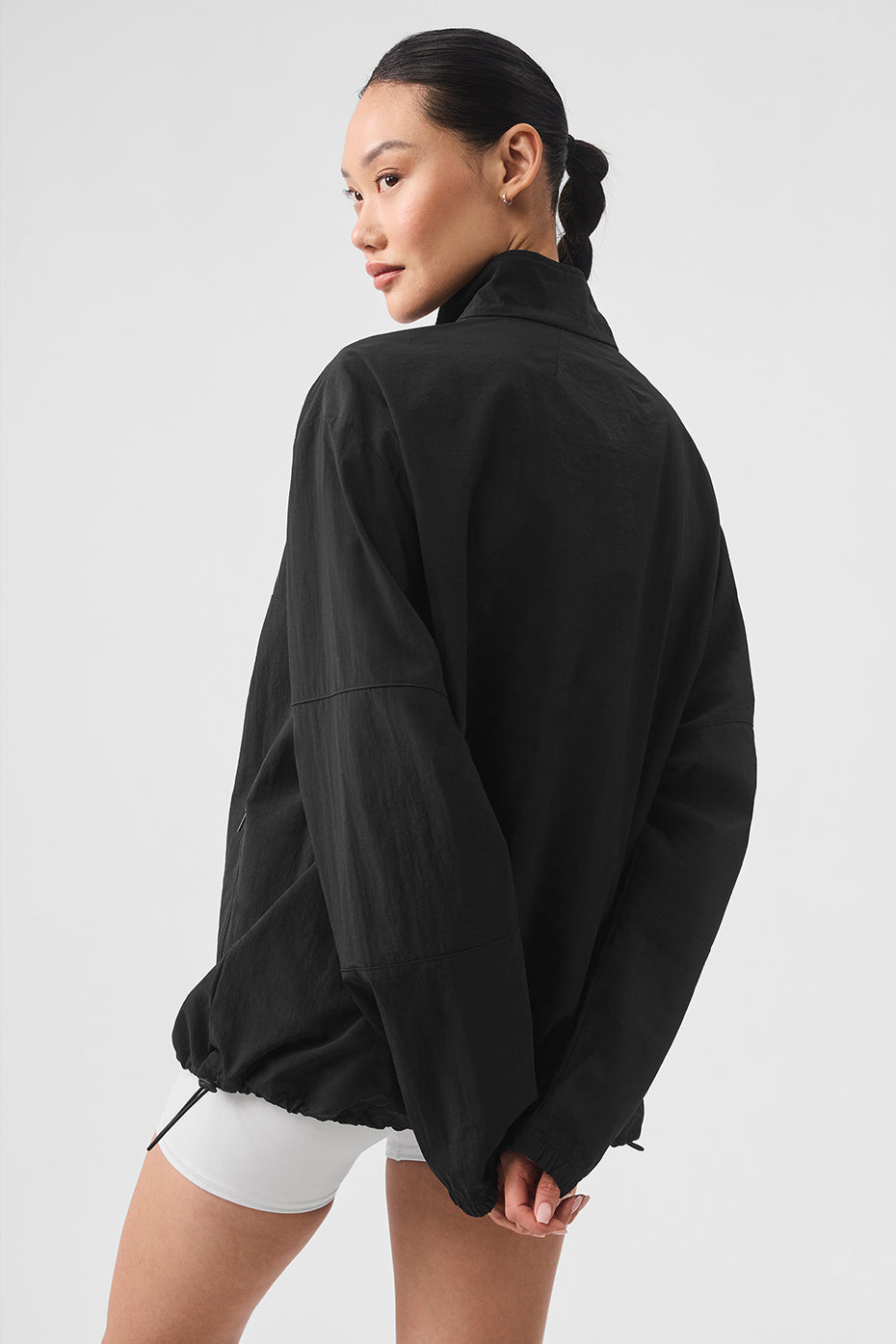 Side view showcasing the relaxed fit and zippered pockets of the pullover.