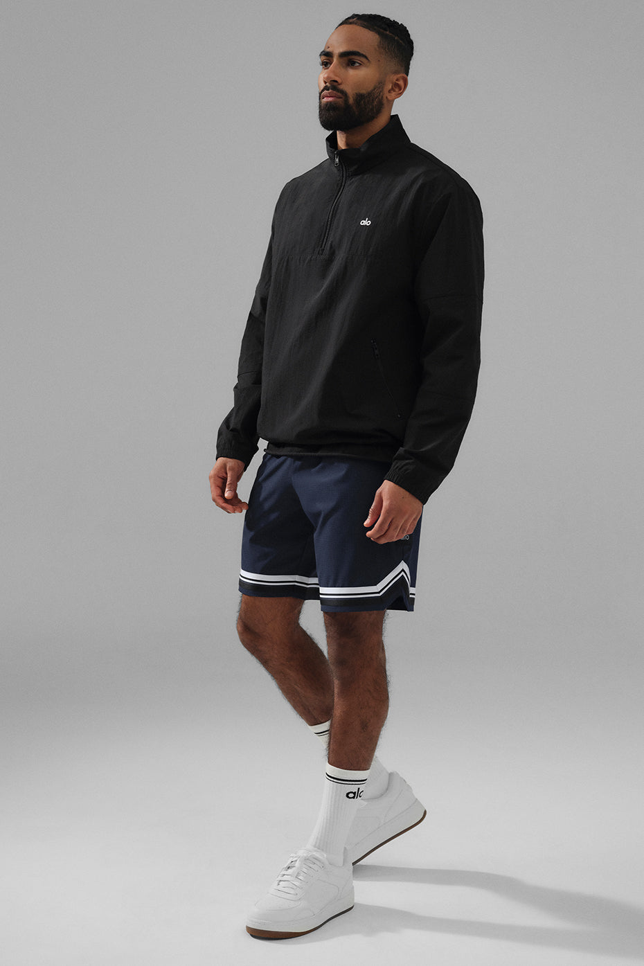 Styled image of a man wearing the mens lightweight pullover during outdoor activity