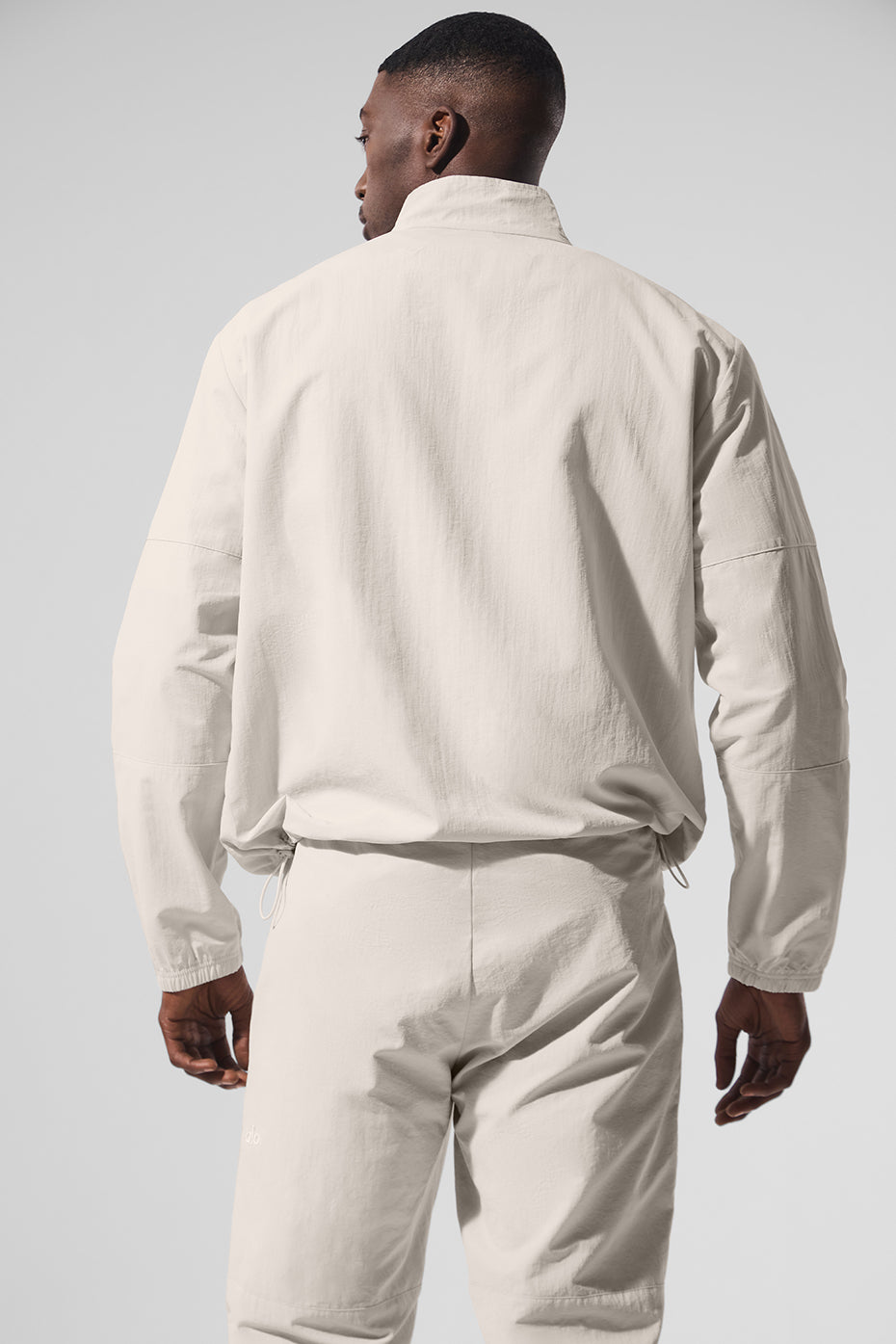 Front view of womens quarter zip top in bone, styled with matching pants
