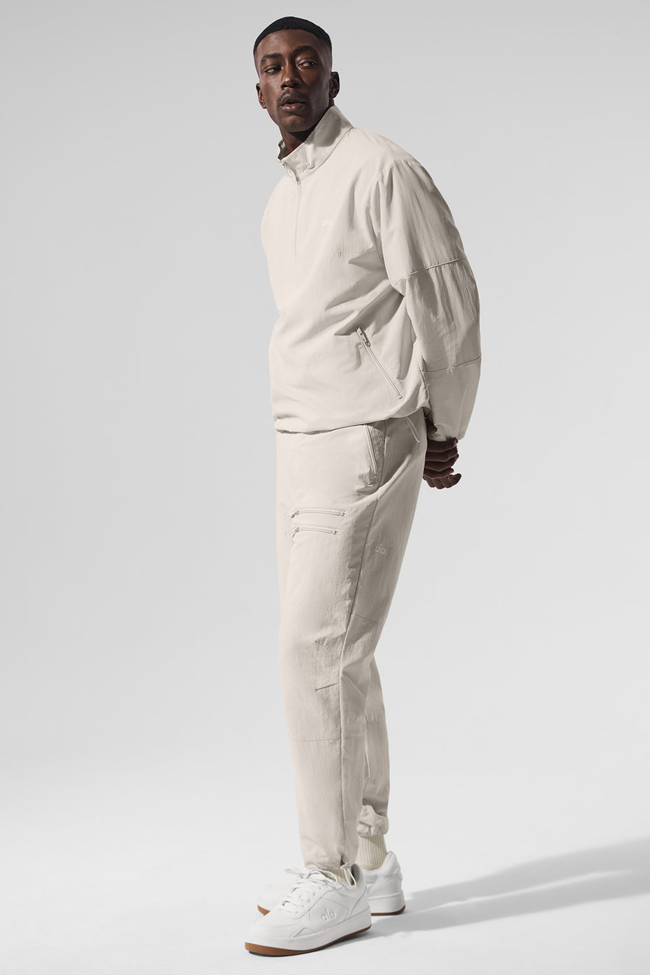 Close-up of quarter zip mens tops style with adjustable bungee hem and zippered pockets