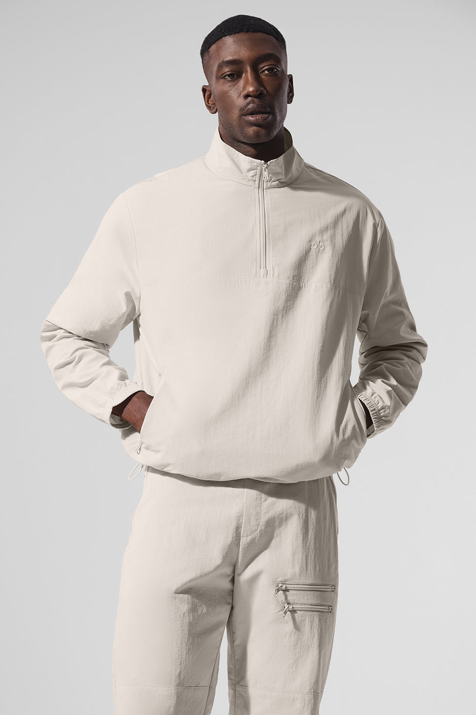 Front view of women's quarter zip top in bone, styled with matching pants