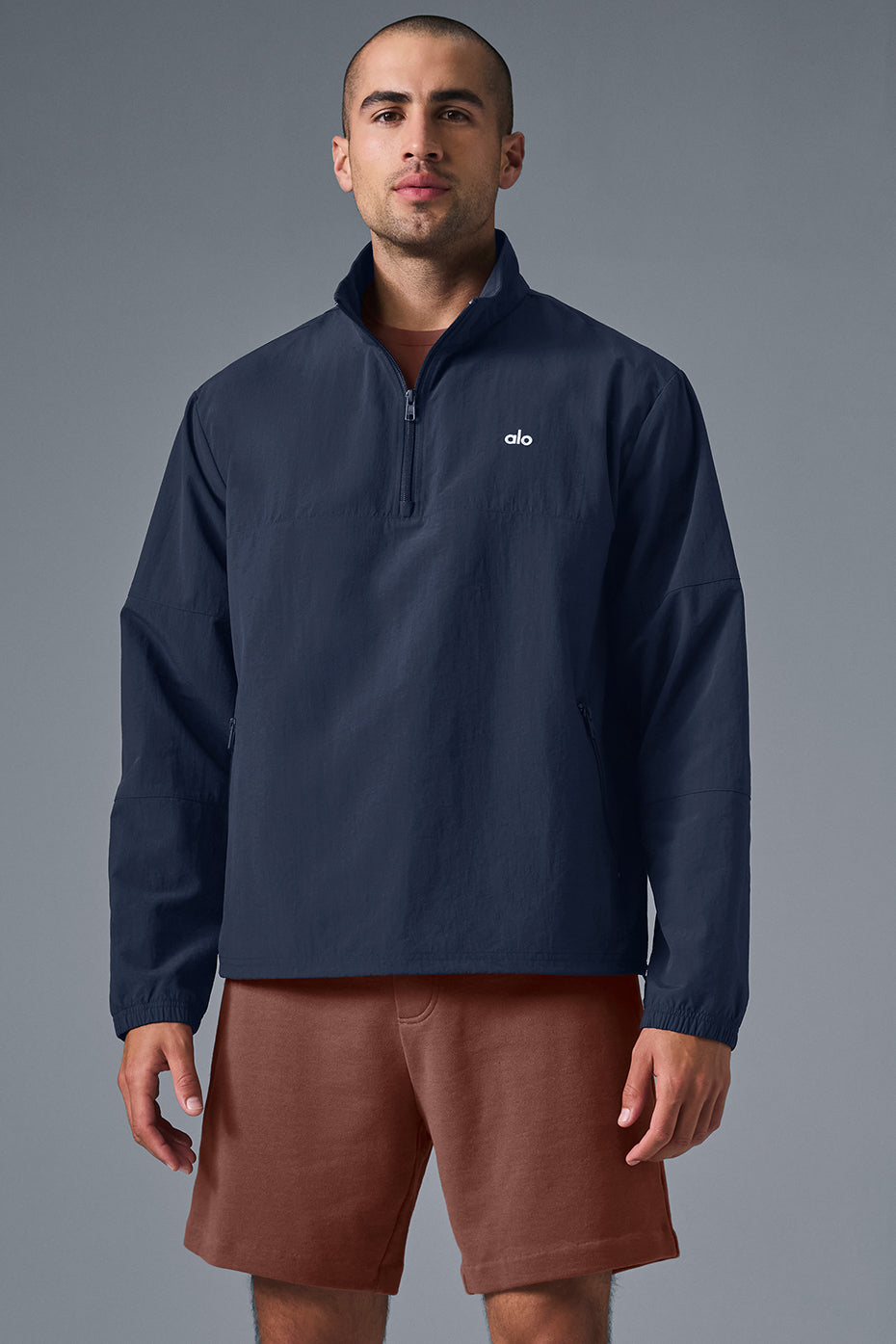 Navy quarter-zip pullover displayed on a hanger, showcasing its lightweight fabric.