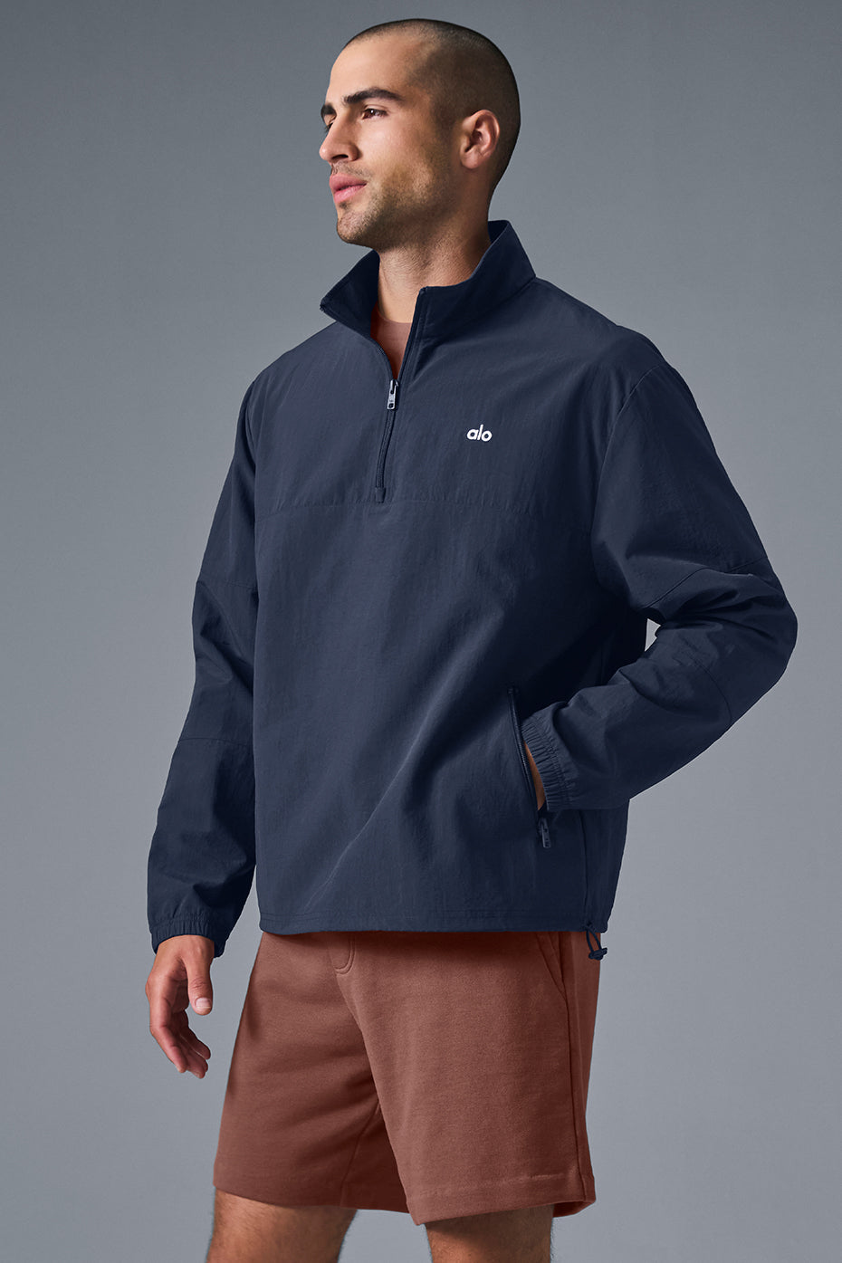 Close-up of the pullovers zippered pocket and quarter-zip neck detail.