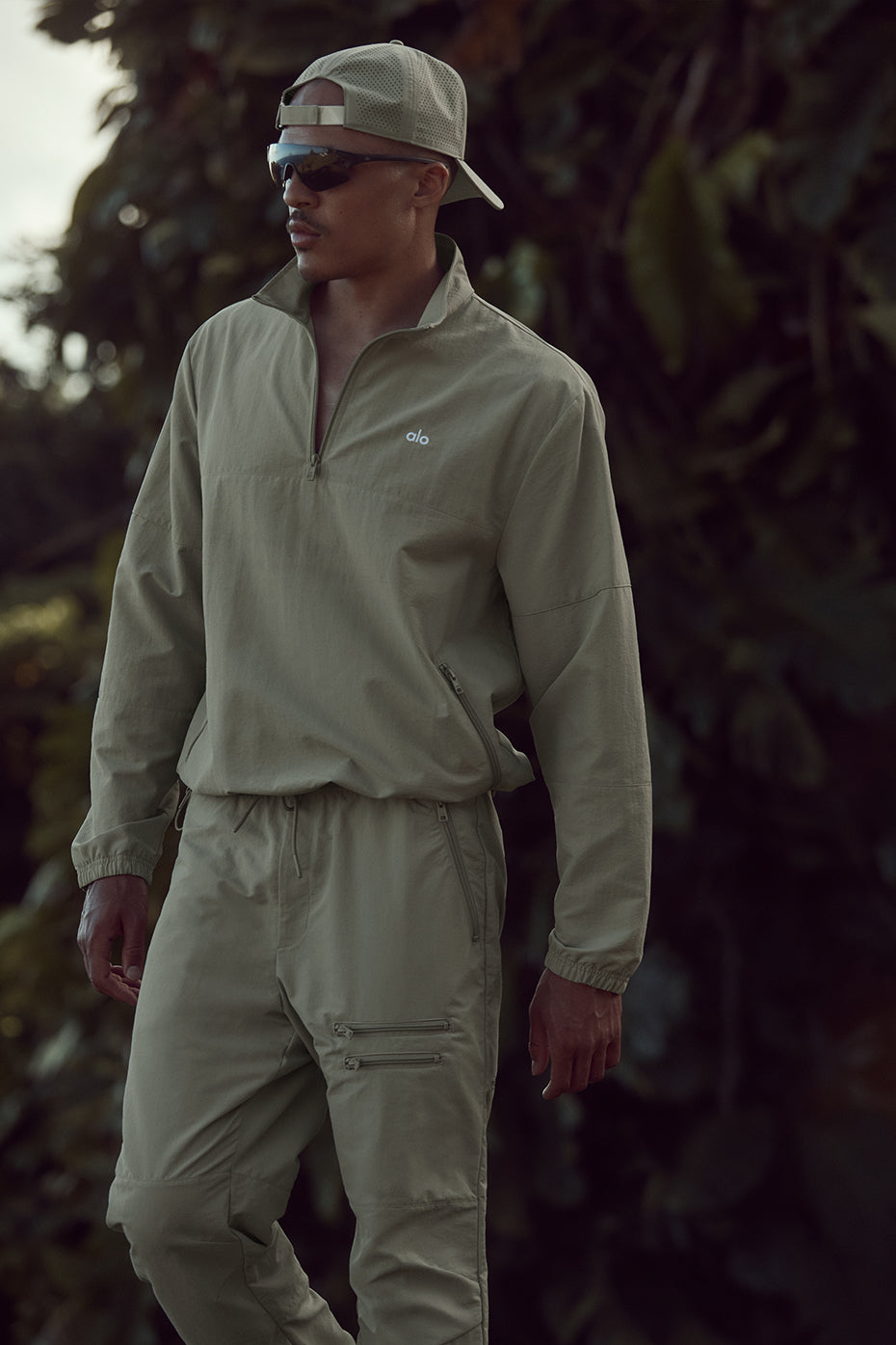 Side view of the quarter zip running top, highlighting the zippered pockets and stretchy cuffs.