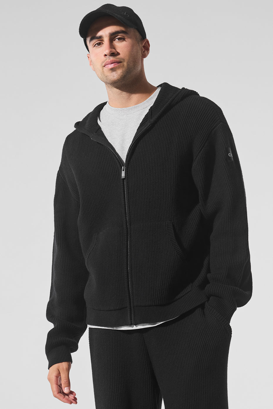 Front view of the oversized cotton sweater in black, showcasing its rib knit texture.