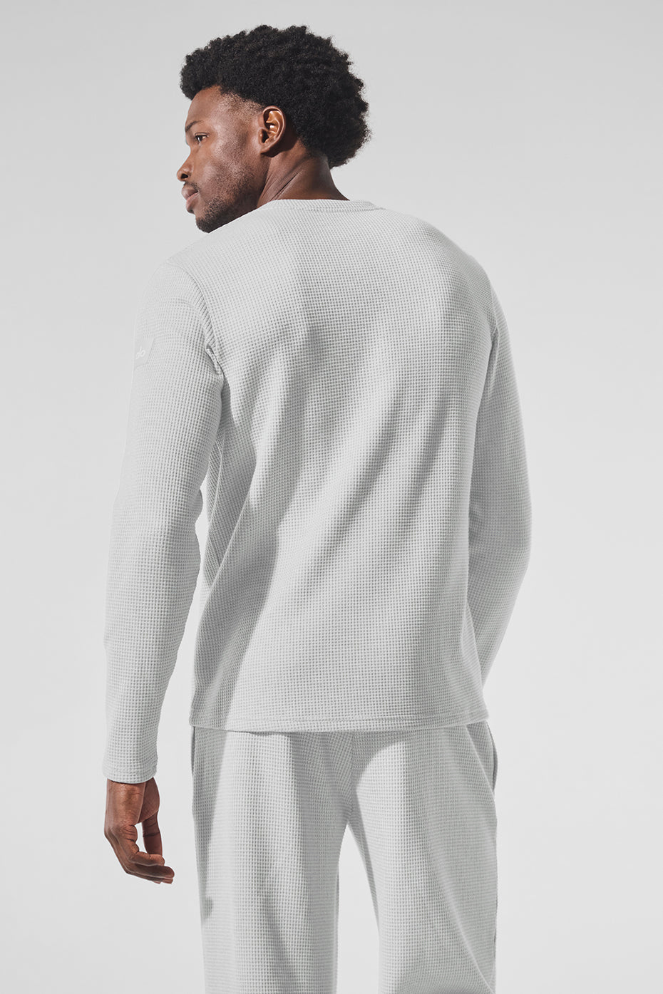Model wearing the long sleeve polo shirt with casual pants.