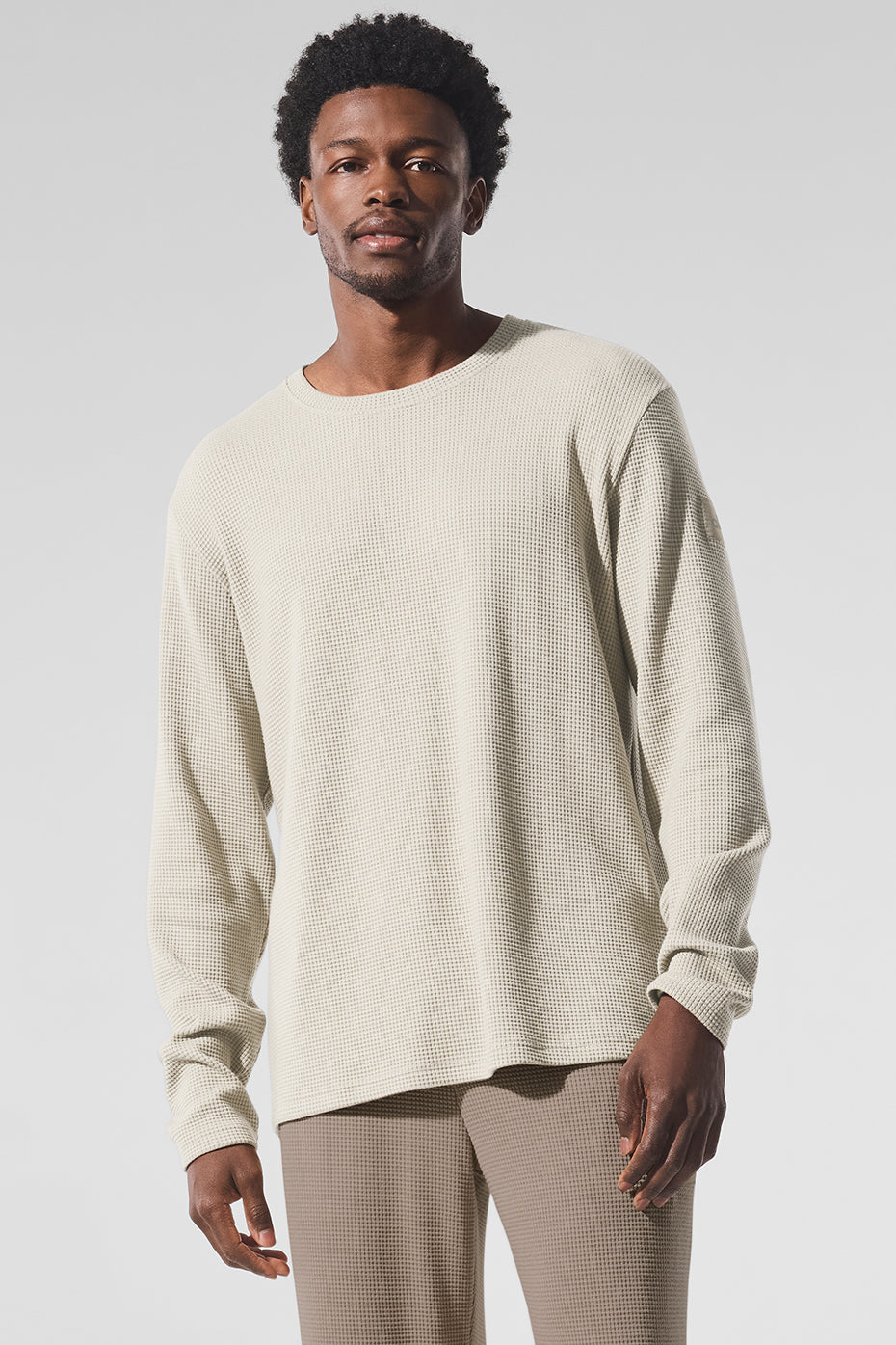 Front-facing view of men's waffle long sleeve shirt in bone, styled with denim.