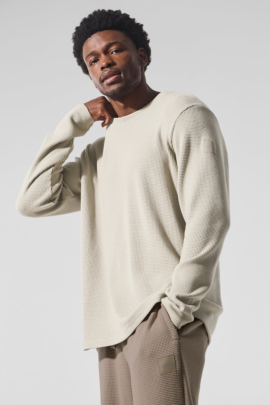 Front-facing view of mens waffle long sleeve shirt in bone, styled with denim.