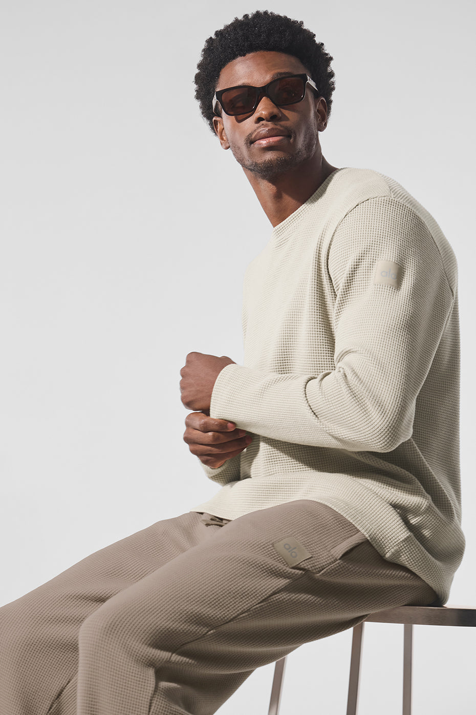 Side angle showing relaxed fit and ribbed cuffs of mens casual top.
