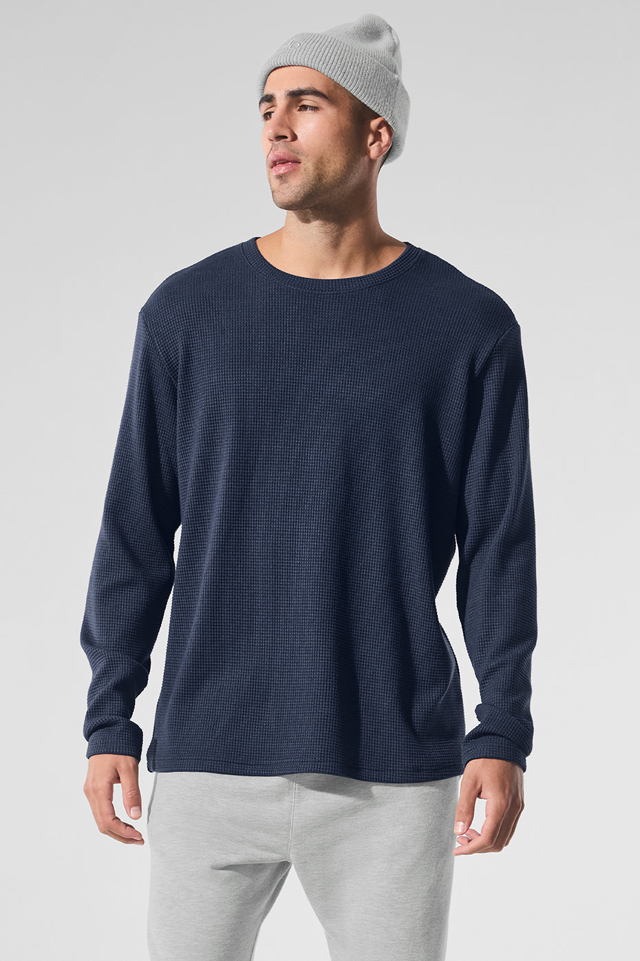 Front view of navy long sleeve shirt displayed with denim jeans