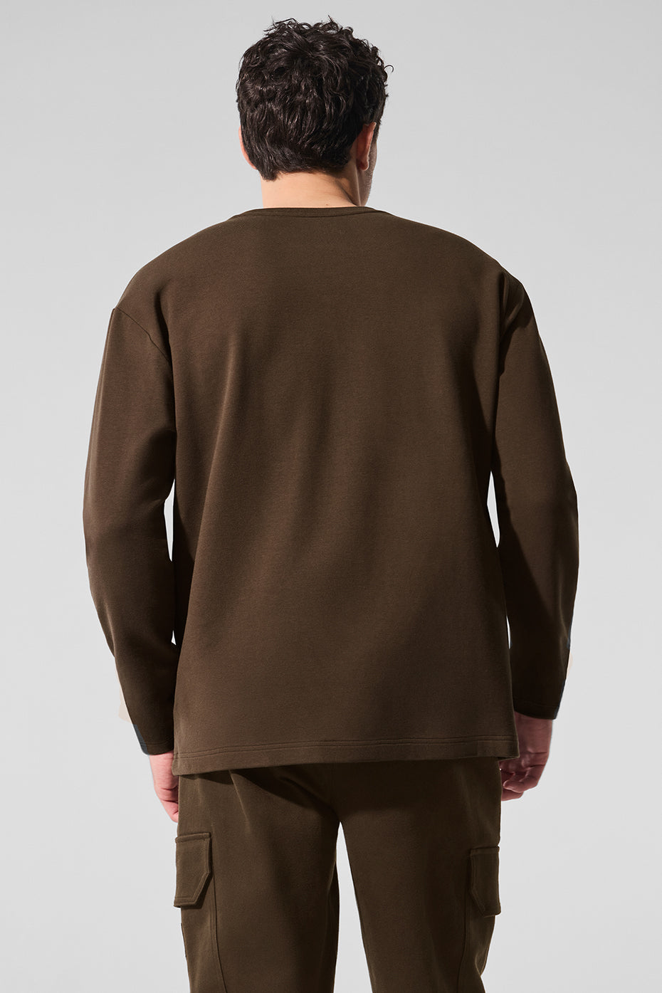 Casual flat lay of the long sleeve shirt, paired with jeans and sneakers.