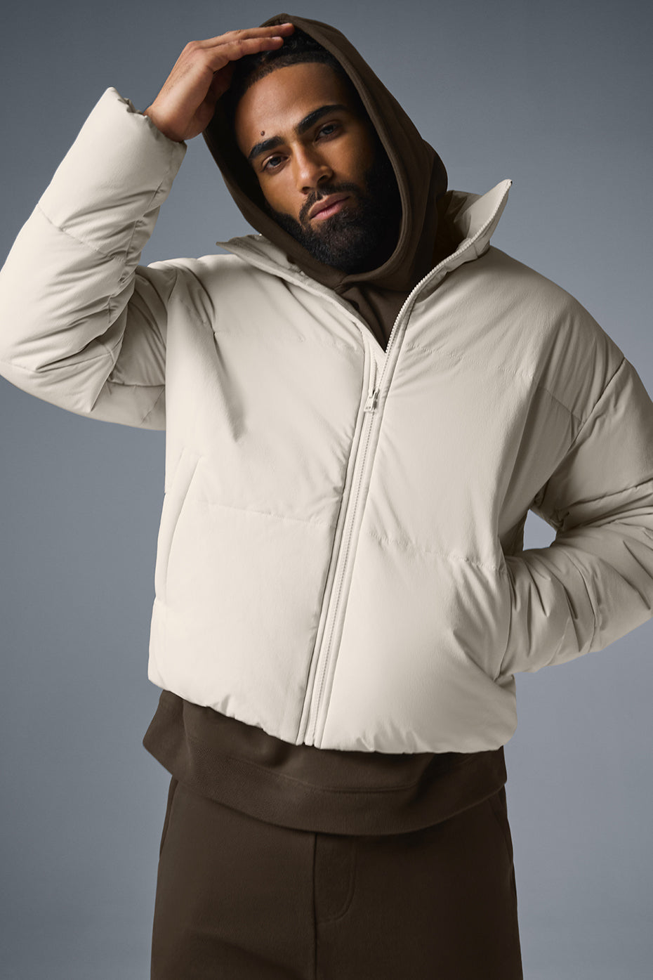 Close-up of full zip closure and pockets on a black puffer jacket