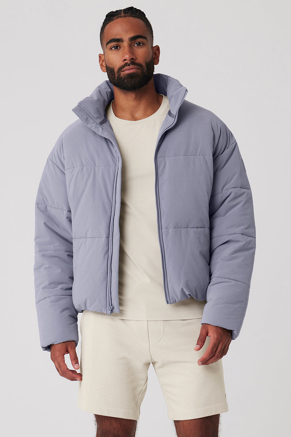 Close-up of the lightweight puffer jacket showing its textured woven fabric and zipper details