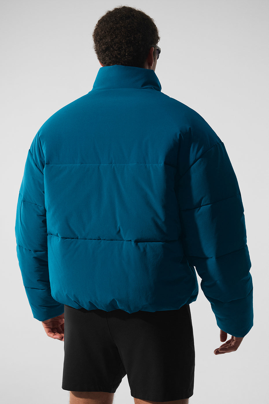 Side profile of the lightweight down jacket highlighting its slim fit and cozy material