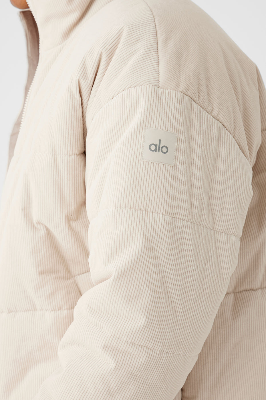 Close-up of corduroy texture and stitching on puffer jacket