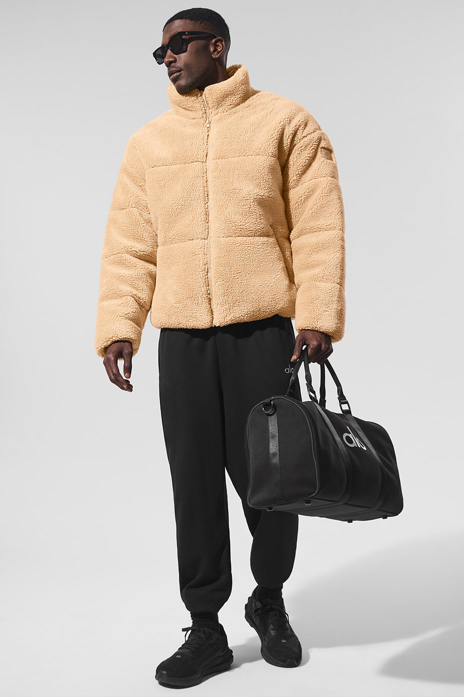 Front view of camel puffer jacket styled for winter walks