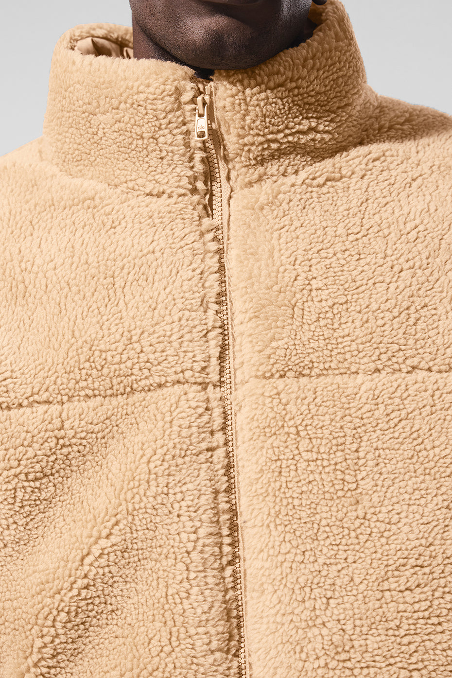 Model wearing sherpa jacket while walking in snowy city park