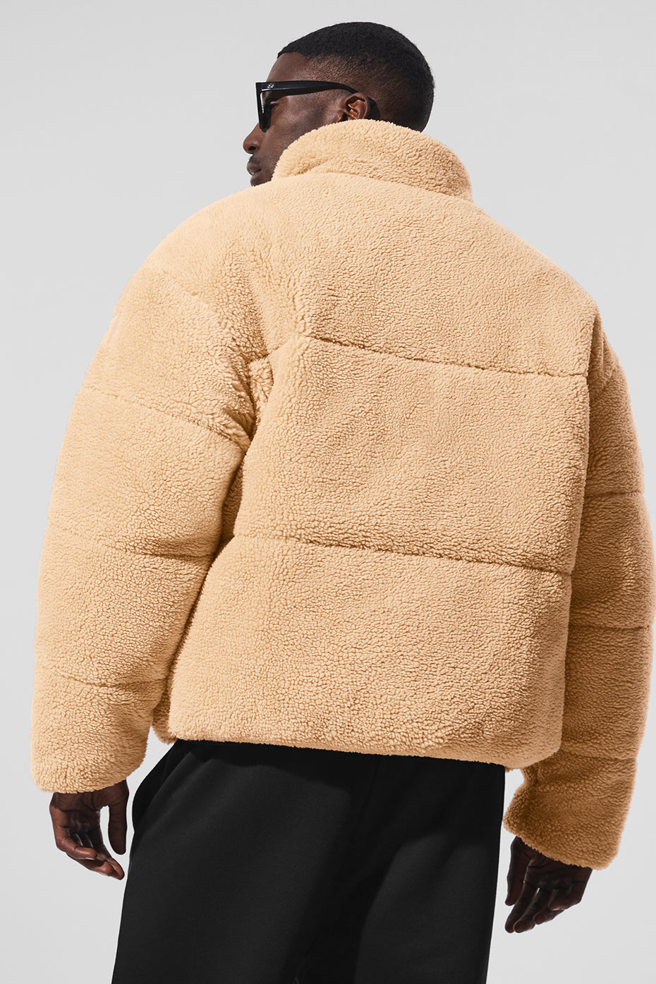 Front view of camel puffer jacket styled for winter walks