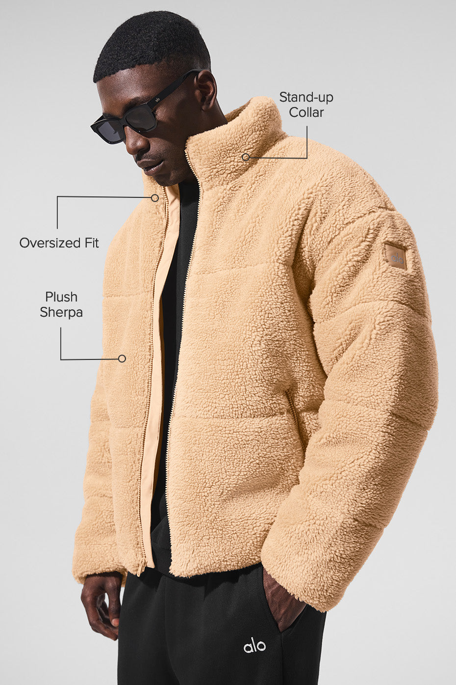 Zipper details and sherpa-lined collar on black puffer jacket