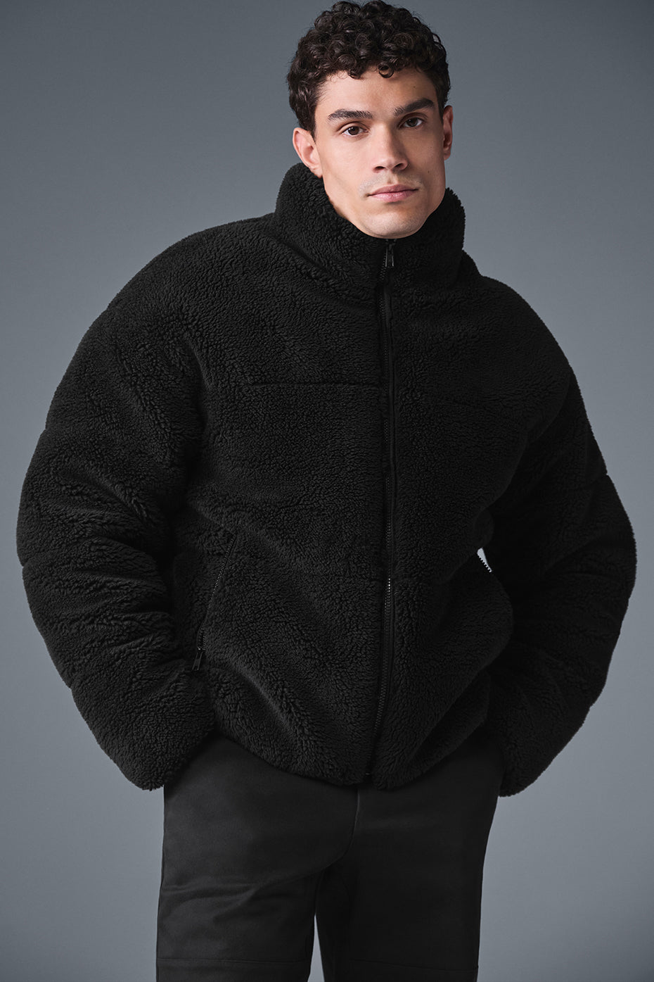 Front view of the cozy sherpa puffer jacket in black, ideal for winter wear.