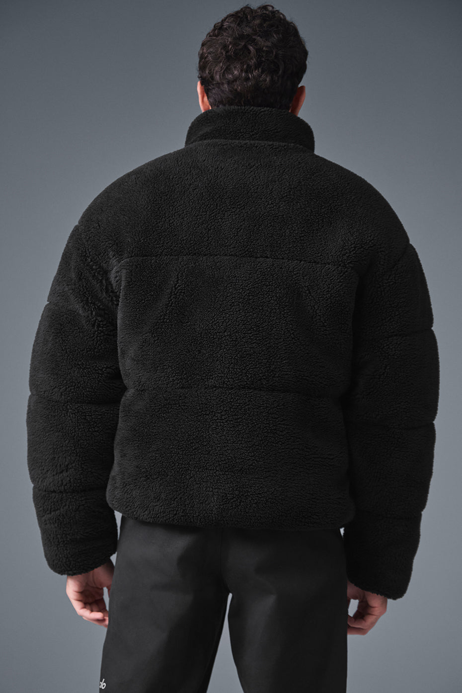 Side view showcasing the zippered pockets of the sherpa puffer jacket.