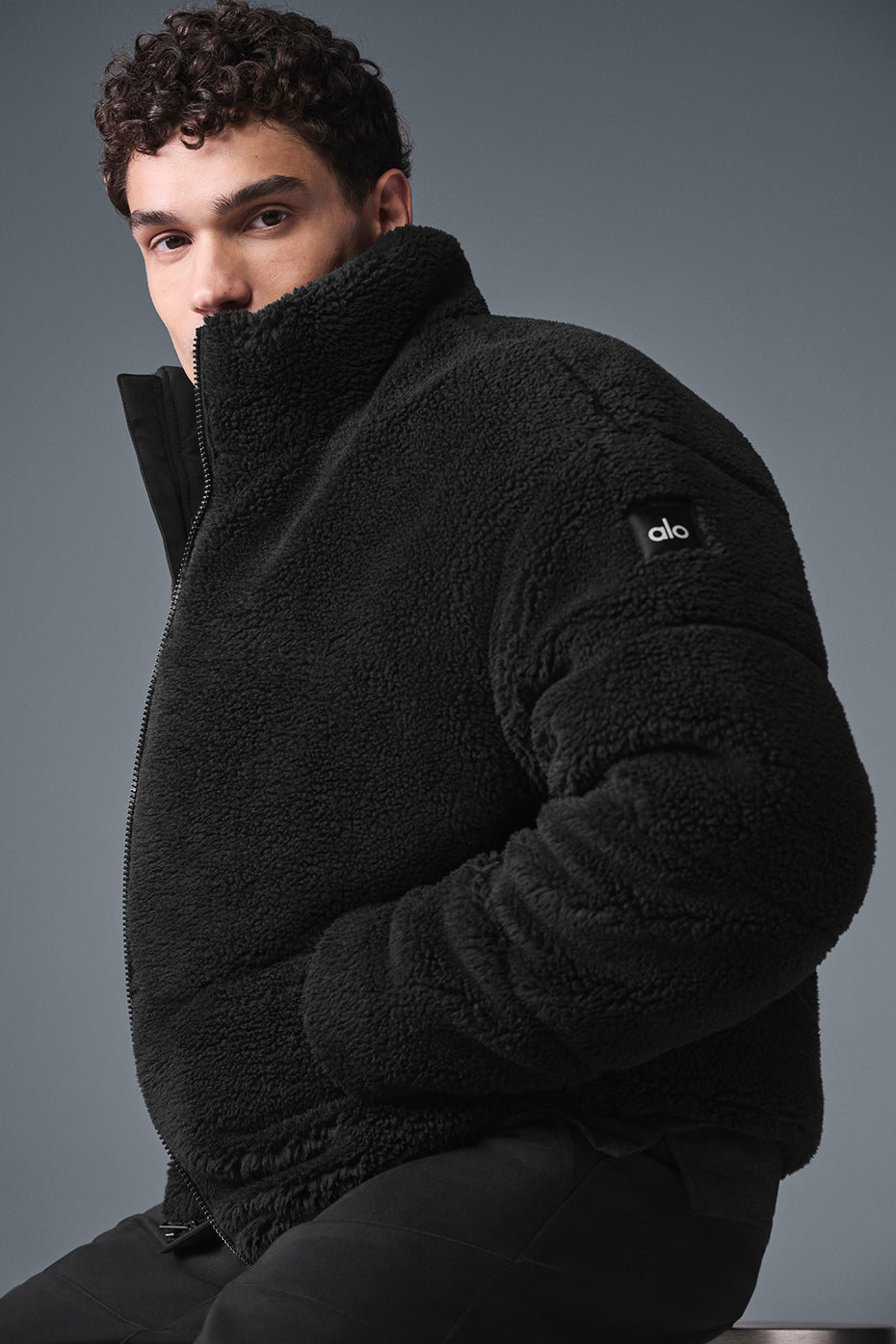 Model wearing the black sherpa puffer jacket, perfect for cold weather.