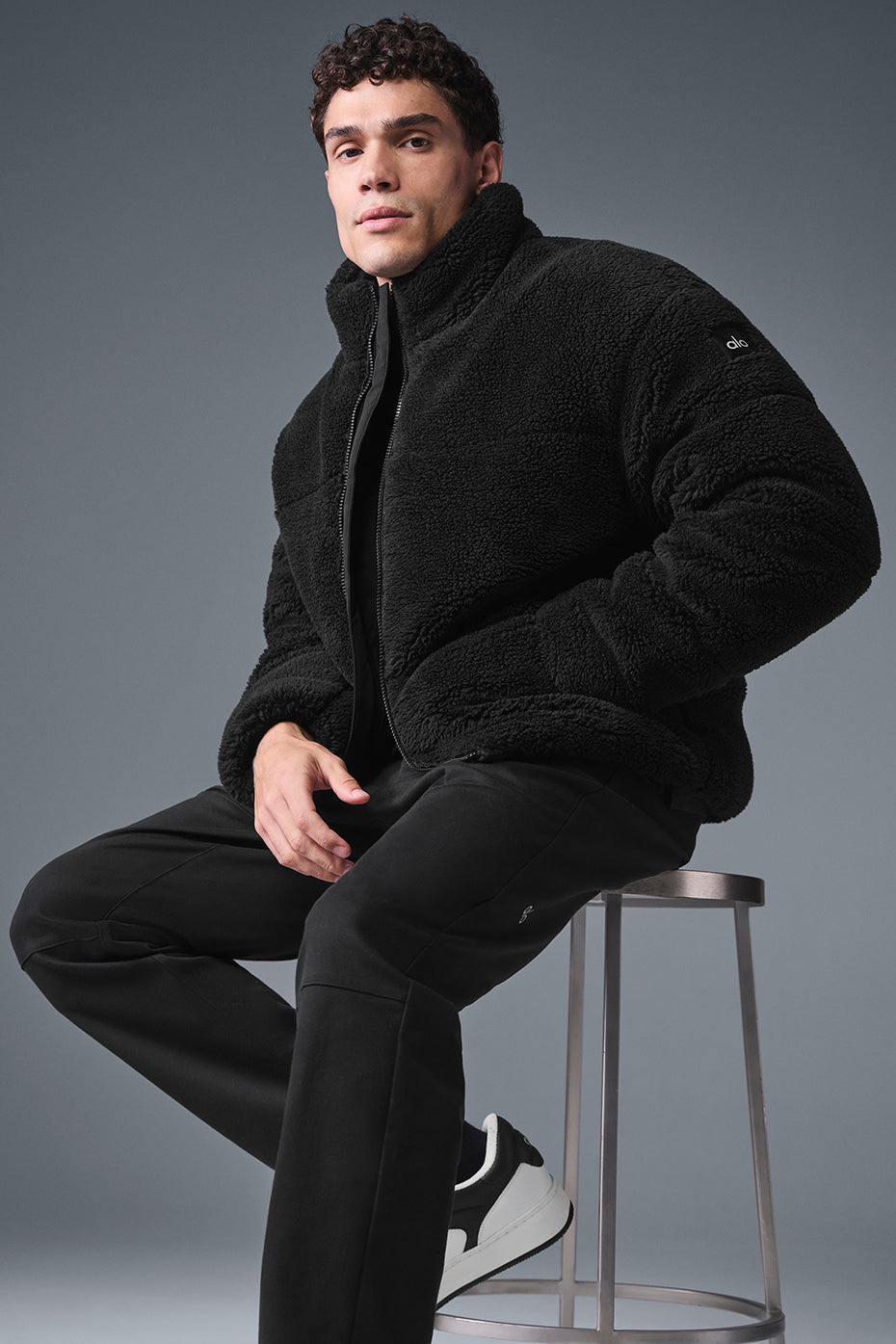 Front view of the cozy sherpa puffer jacket in black, ideal for winter wear.