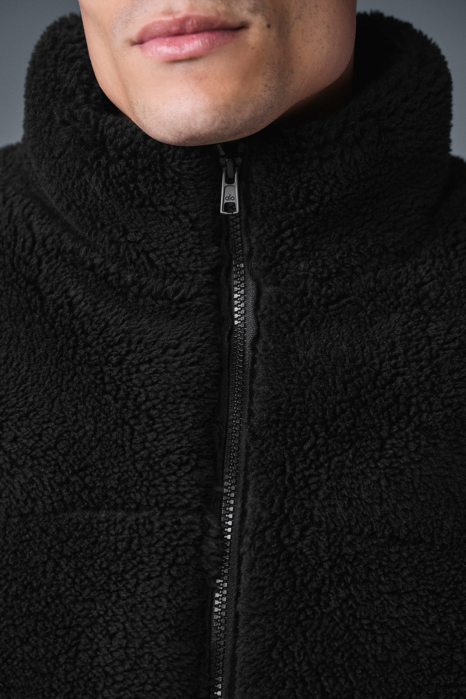 Side view showcasing the zippered pockets of the sherpa puffer jacket.