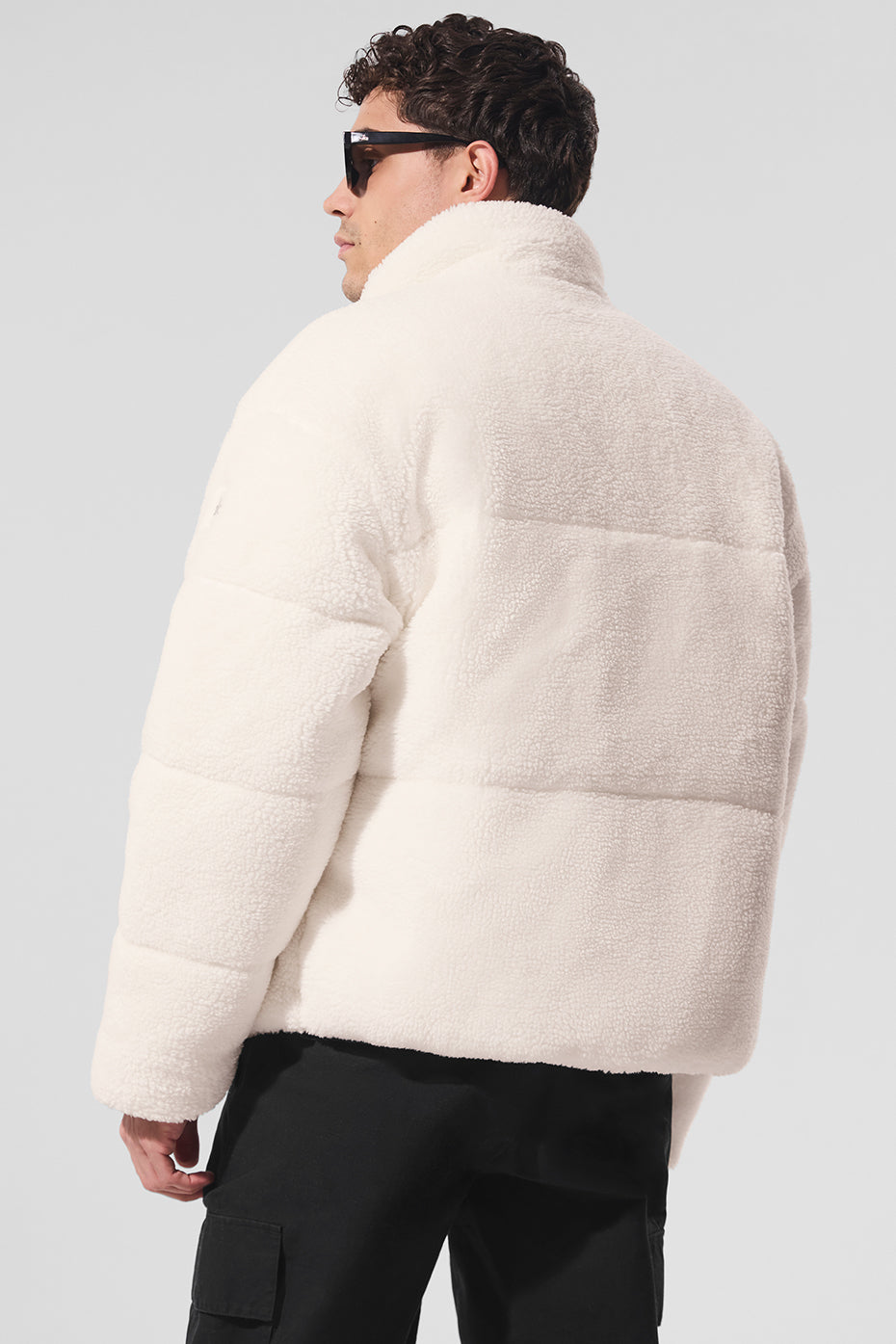 Front view of ivory sherpa puffer jacket showcasing its cozy design.