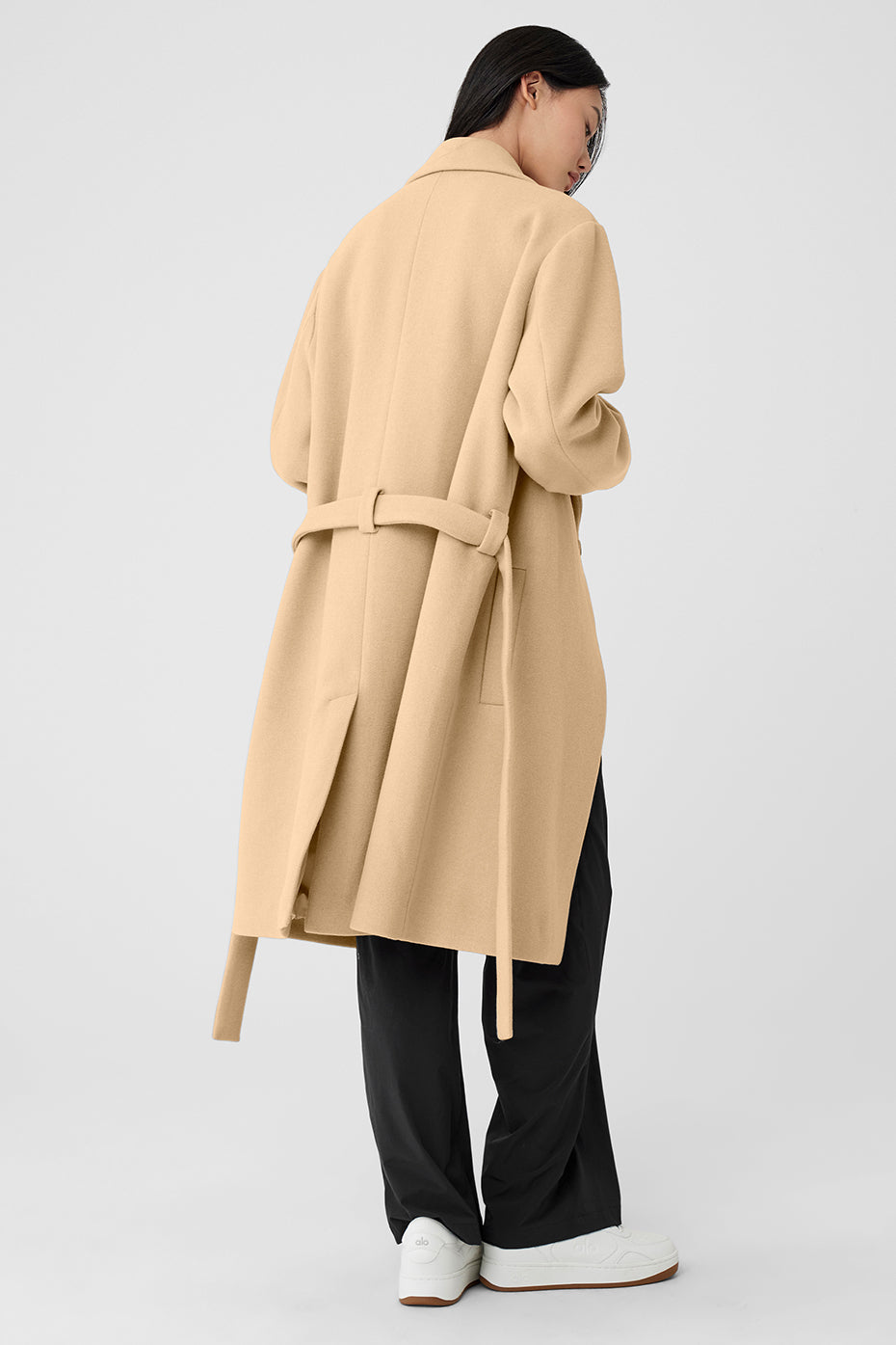 Close-up of the camel hair coat’s textured fabric and lapel detail