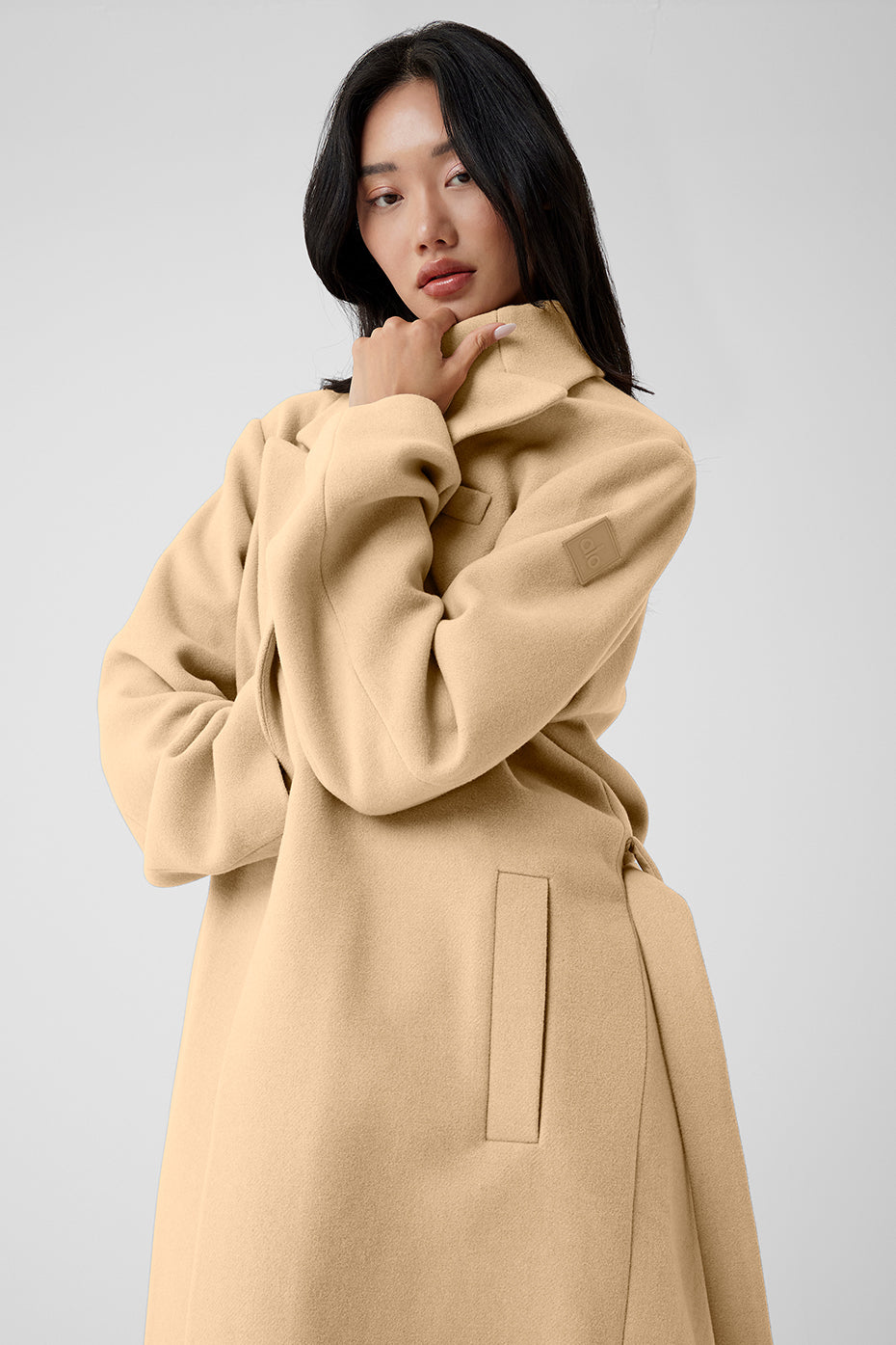 Close-up of the camel hair coat’s textured fabric and lapel detail