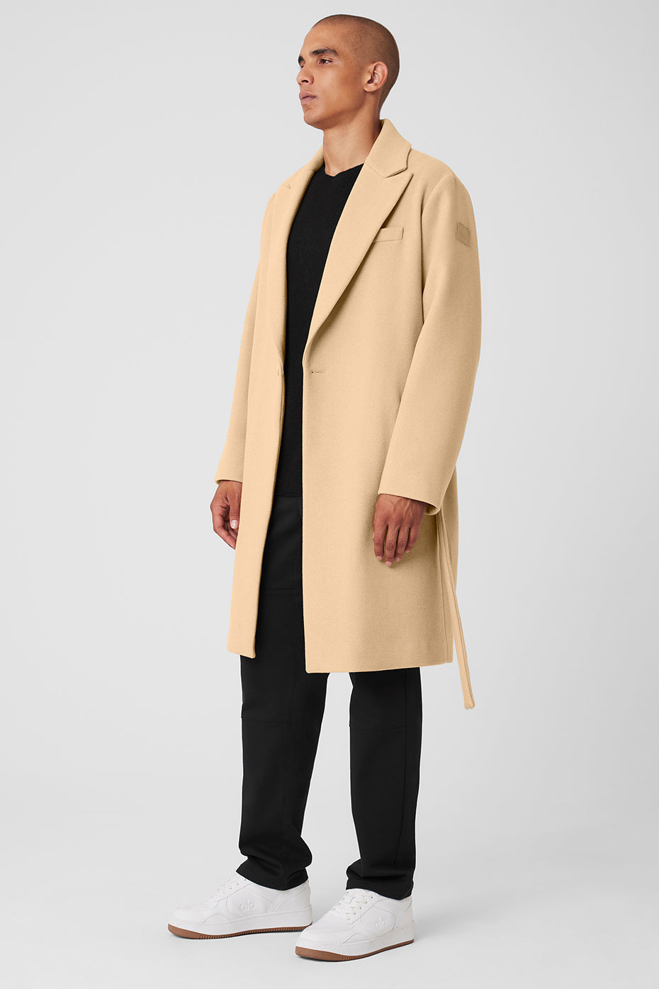 Long wool coat worn open over casual layers, ideal for cold urban mornings