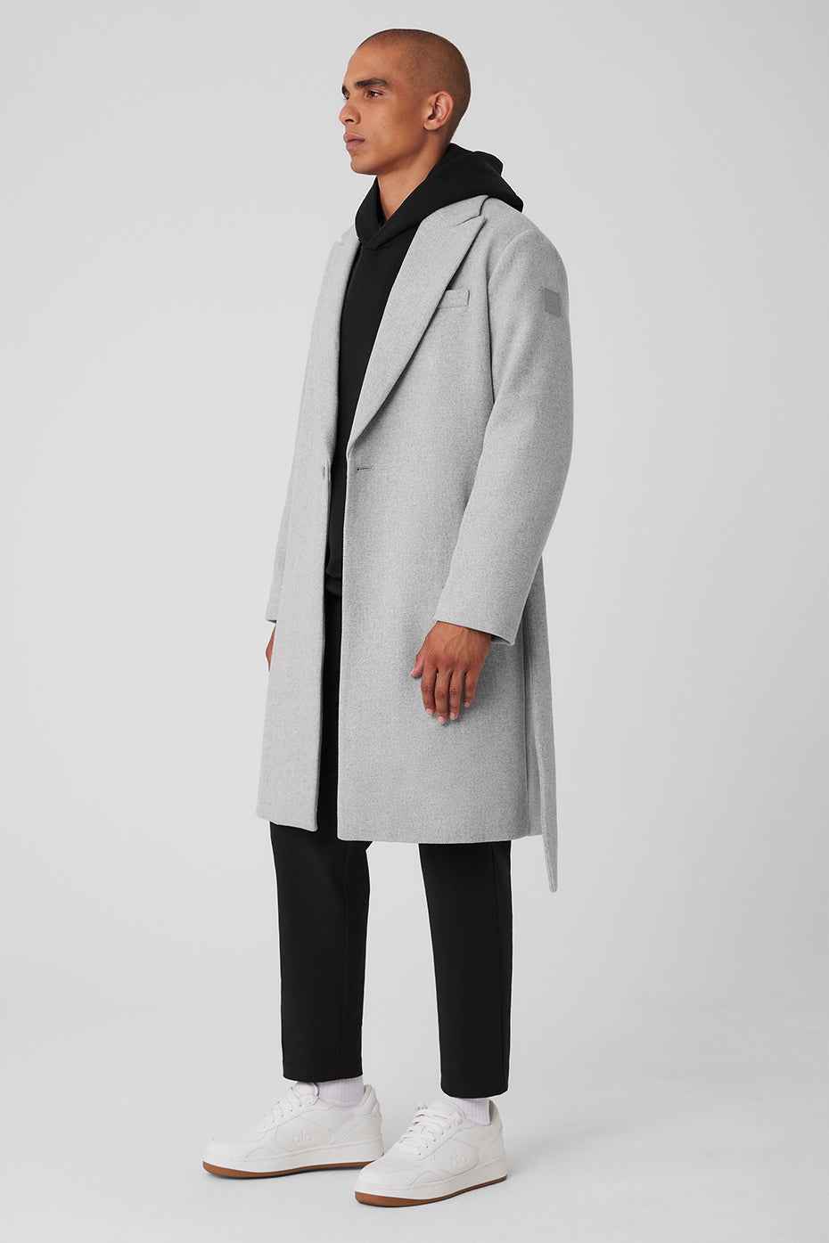 Model wearing Gameday wool overcoat outdoors on a chilly day.