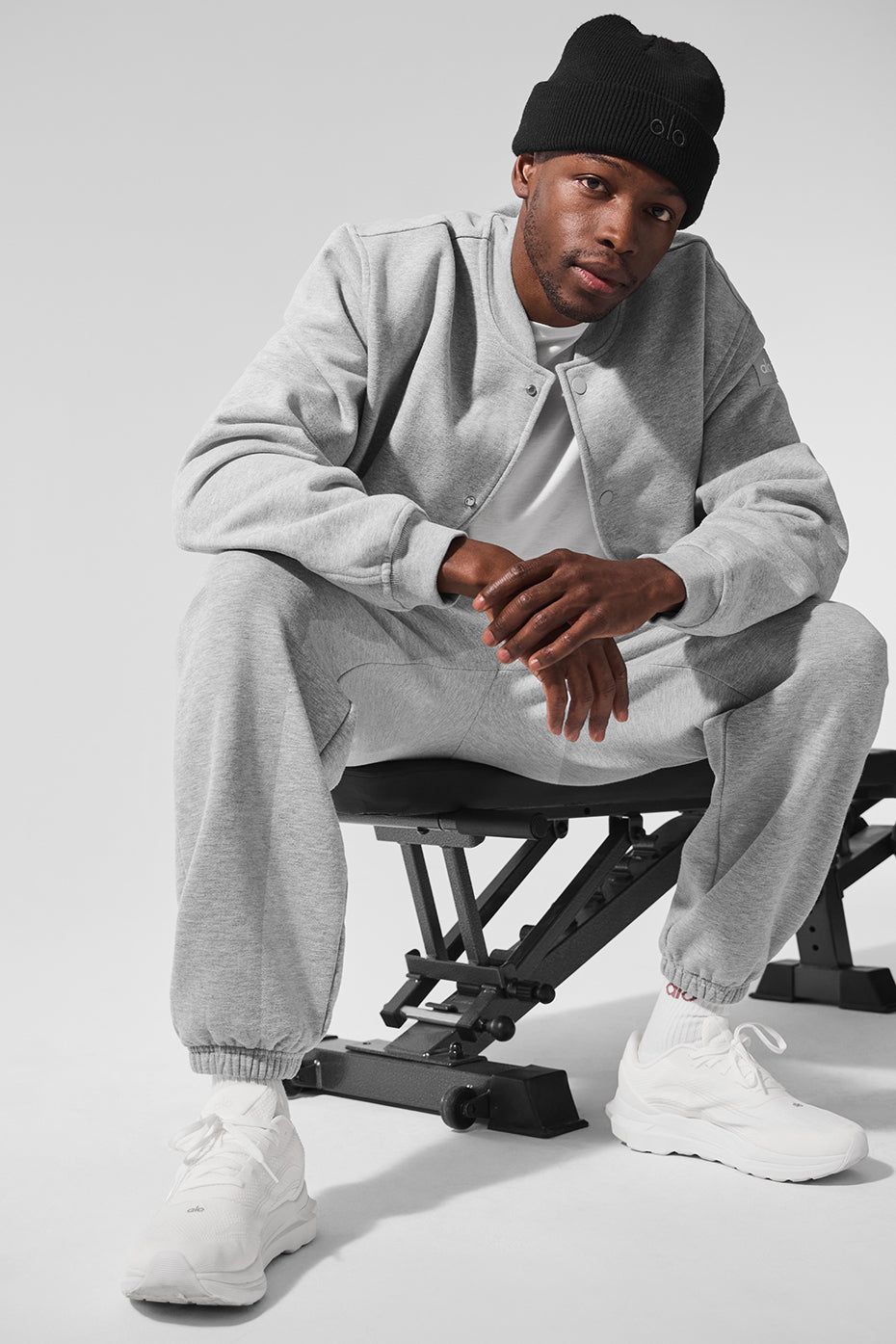 Model wearing the mens varsity jacket in athletic Heather grey outdoors