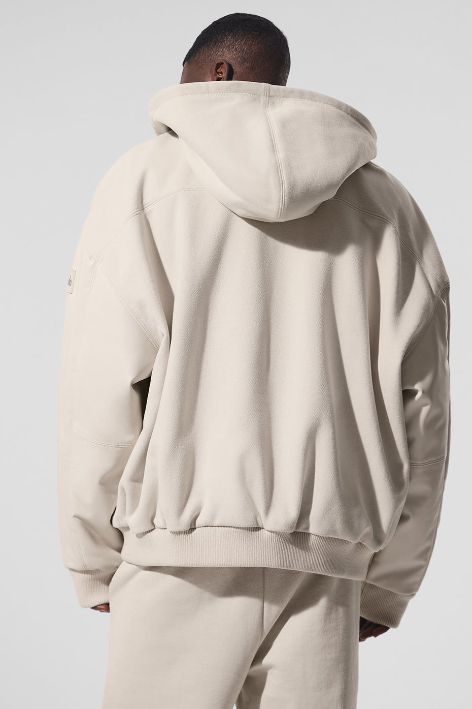 Model wearing Urban Edge Hooded Bomber Jacket, demonstrating its stylish fit.