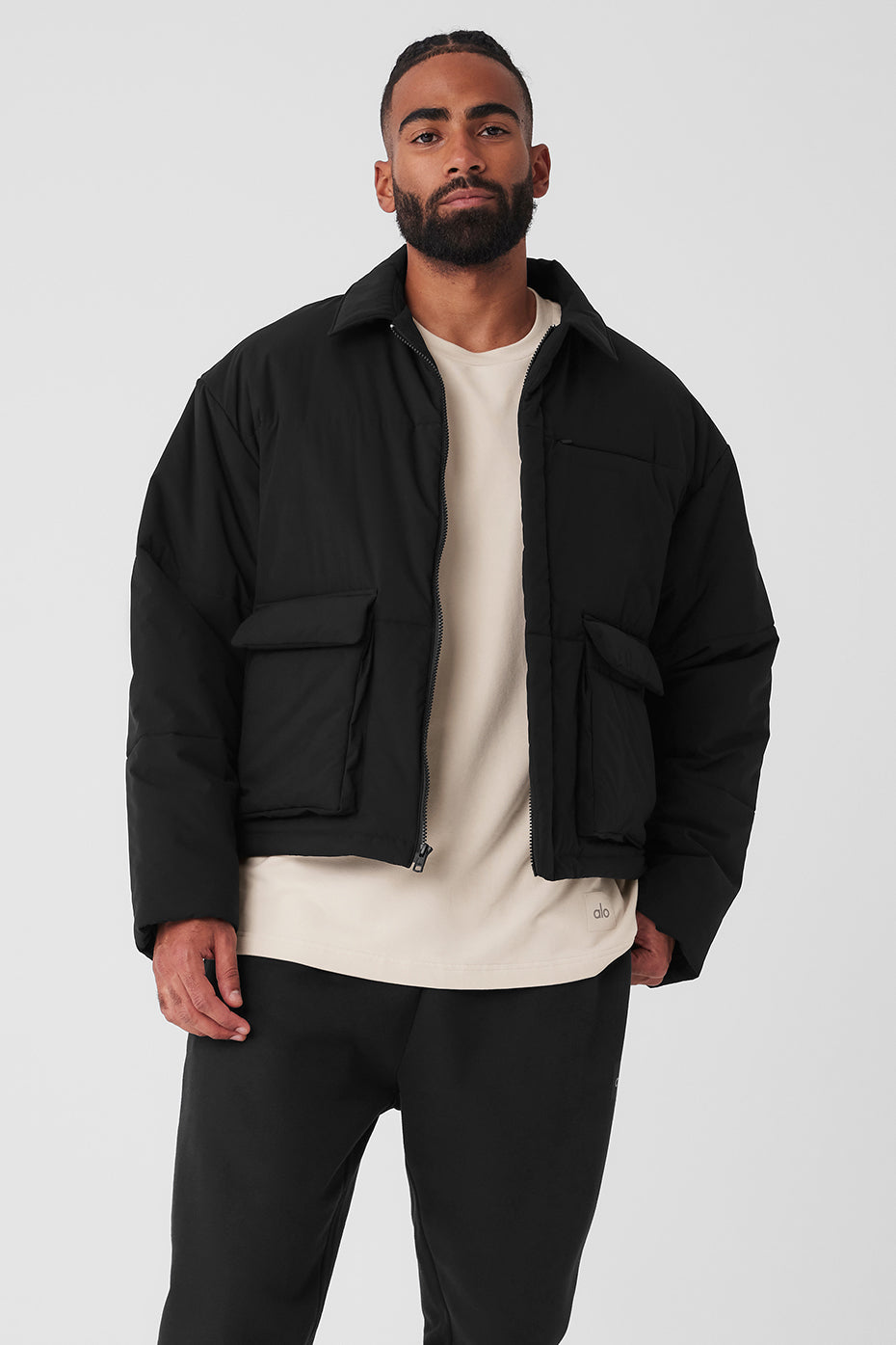 Black utility cargo jacket with oversized front pockets and sharp collar, styled for men and women
