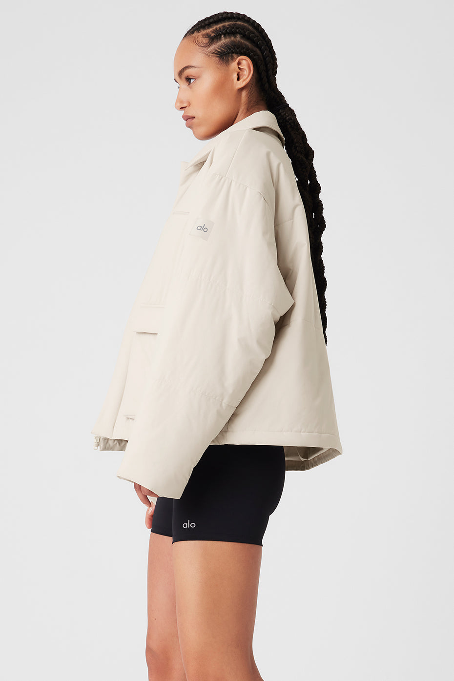 Backlit shot of jacket layered over a hoodie for autumn styling