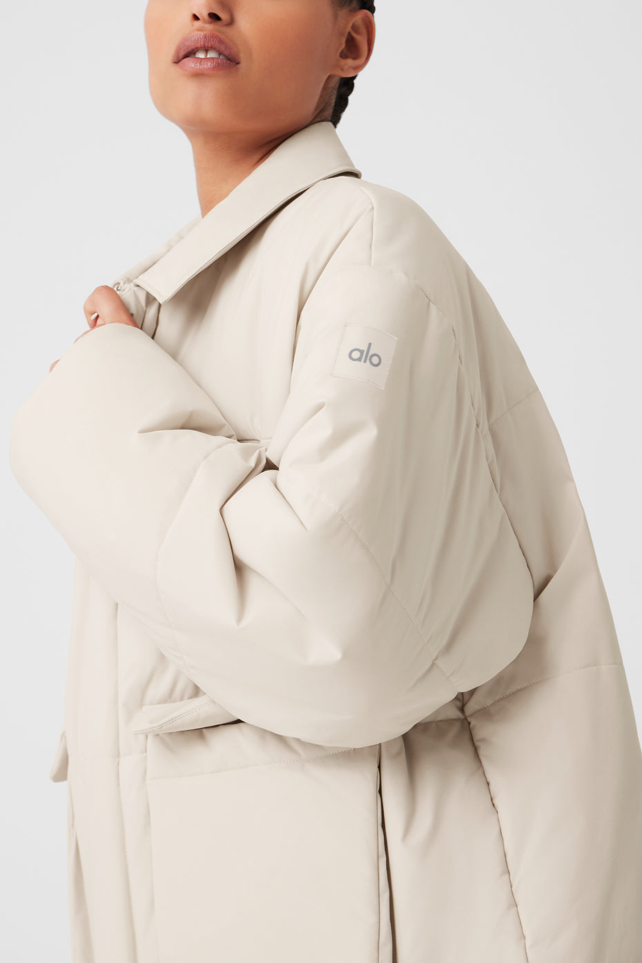 Side view modeling the jacket’s oversized cargo pockets and sharp collar