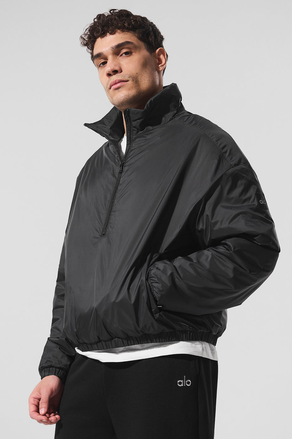 Front view of the Latitude lightweight half zip pullover jacket in black, perfect for workouts.