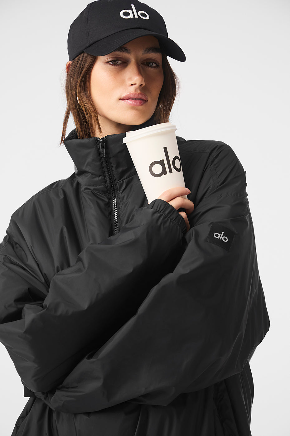 Side view of the black pullover jacket with zippered pockets, perfect for rainy runs.