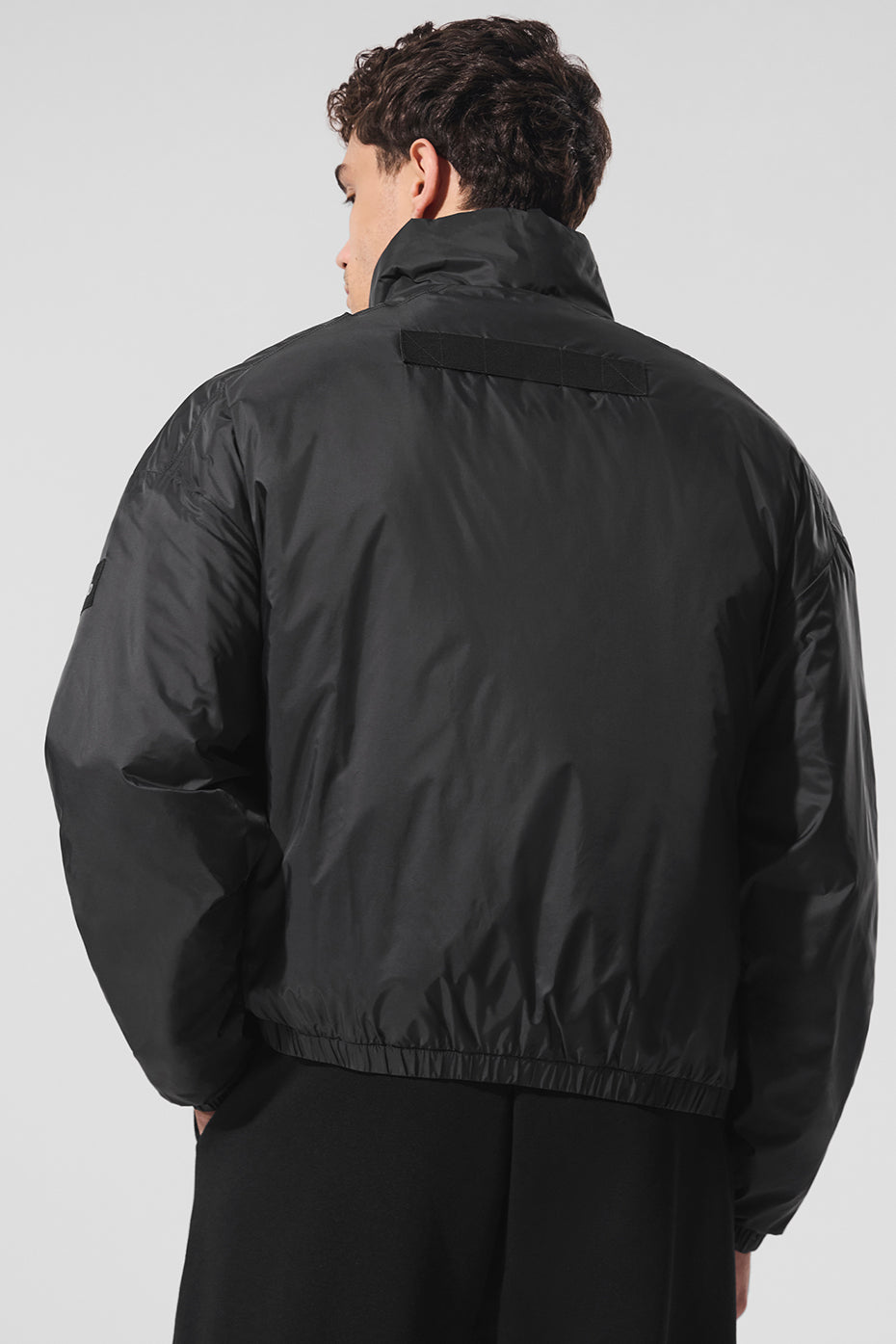 Back view of the Latitude pullover jacket, highlighting its comfortable fit and banded cuffs.