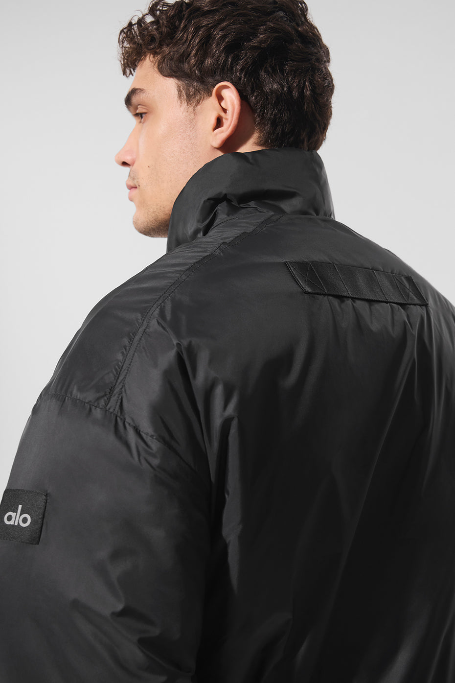 Front view of the Latitude lightweight half zip pullover jacket in black, perfect for workouts.
