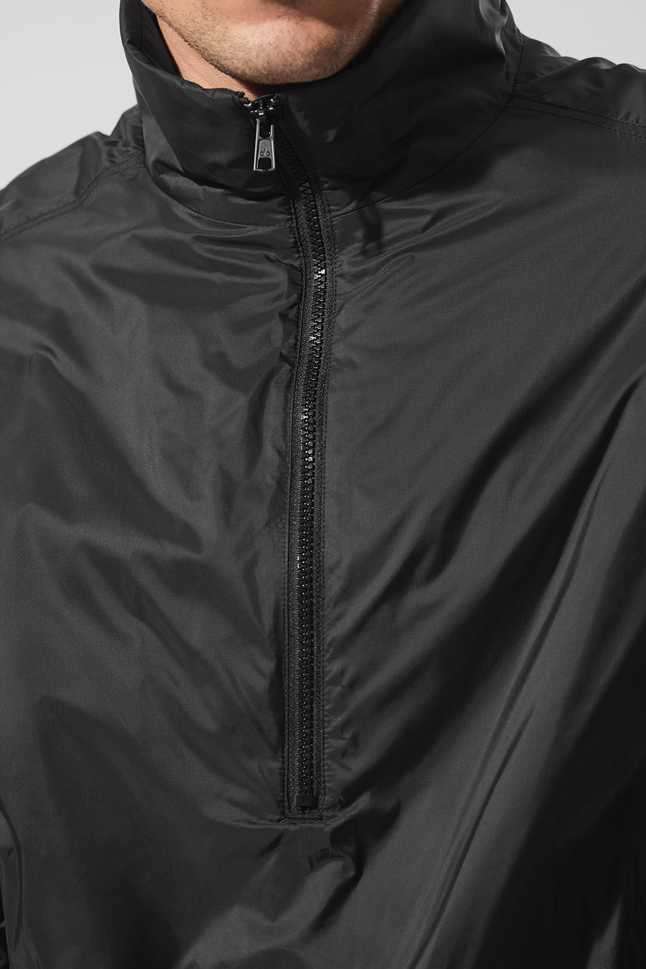 Side view showcasing the zippered pockets of the pullover jacket, ideal for outdoor activities.