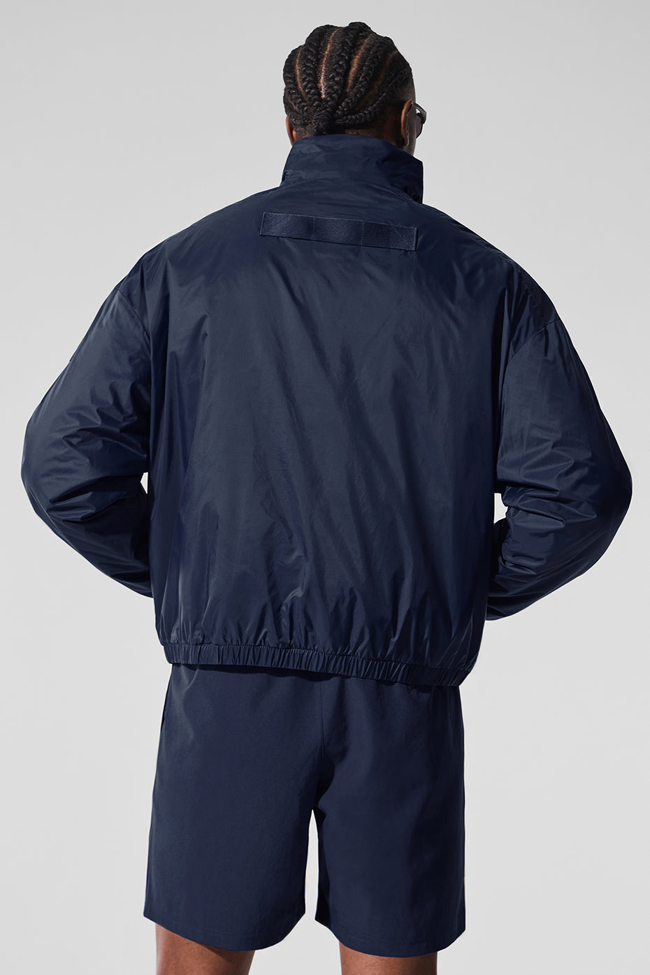 Side view showcasing the zippered pockets of the pullover.