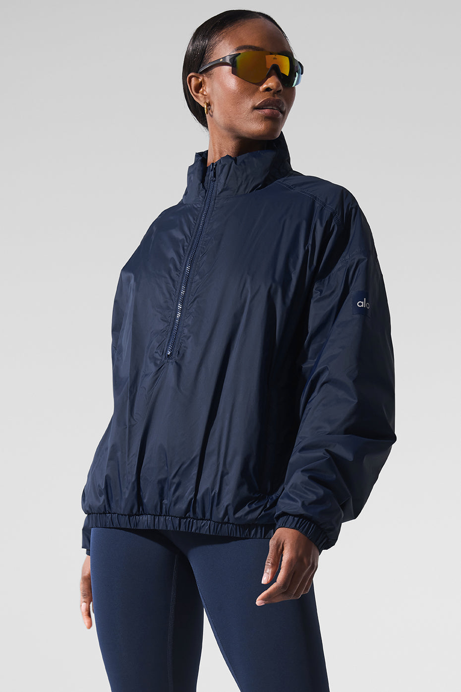 Front and back view of the womens running jacket with zippered pockets.