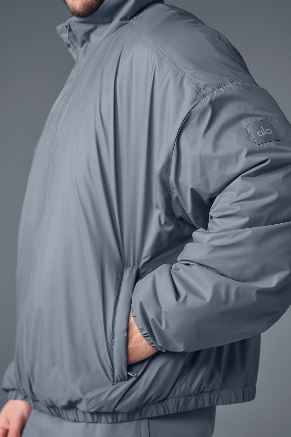 Front view of steel grey lightweight pullover worn during a morning run