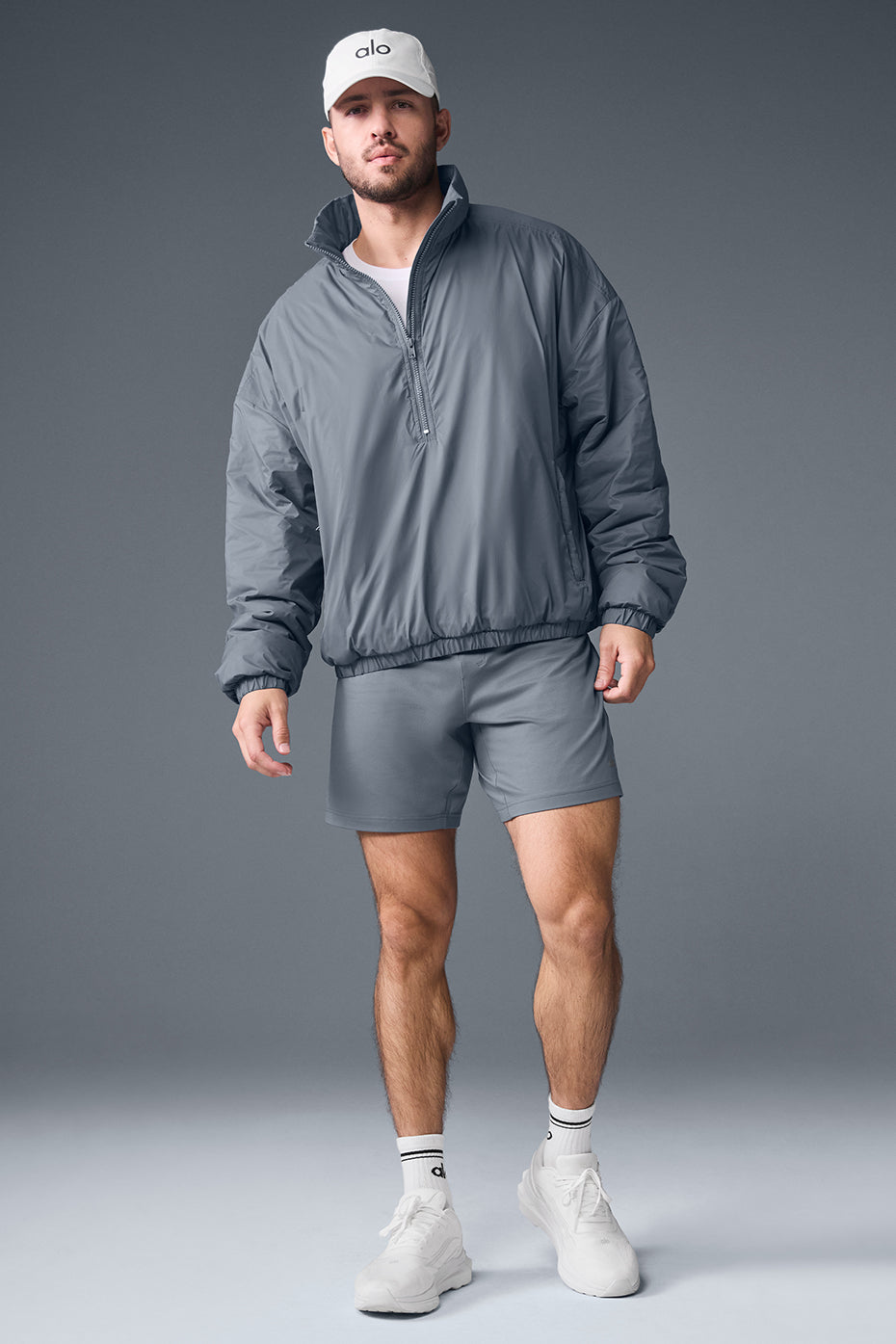 Side profile of half-zip jacket with zippered pockets and banded cuffs
