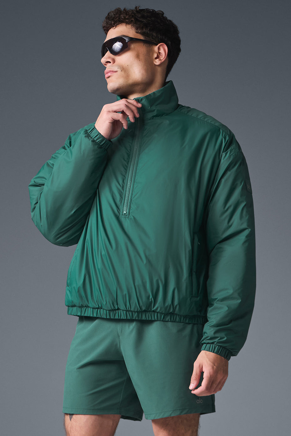 Front view of lightweight nylon running jacket with half-zip for men and women