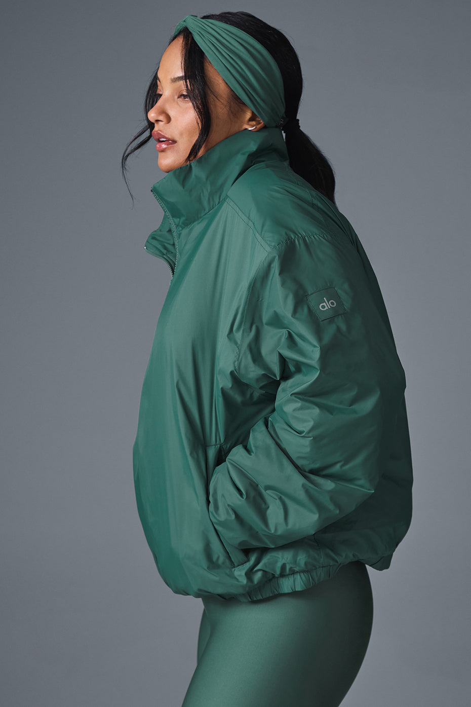 Close-up of the half-zip collar and zippered side pockets of the jacket.